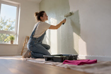 Ouder schildert veilig de muur van een babykamer